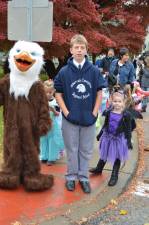 The Immaculate Conception Eagle Mascot along with another seventh grade student lead the younger students to Westwind Manor.