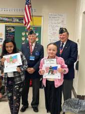 Franklin Elementary School student Mia Perna, right, won first place and Angemily Soto placed third in the annual Coloring Contest sponsored by the Sgt. Francis M. Glynn Franklin American Legion Post 132. The awards were presented by Robert Caggiano, left, and John Kopcso. (Photos provided)