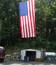 This giant, probably 100-foot, American flag hangs in the parking lot of Firehouse Bagel Company in Franklin.
