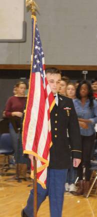 Specialist John Sheldon, Wallkill Valley graduate and former FBLA member, presents the American flag at the Veterans Day assembly on Nov. 11.