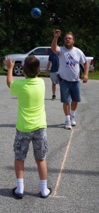 Elks member Rick Green of Wantage tosses a ball to a youngster wearing &quot;Drunk Driving Goggles.&quot; Catching the ball is not nearly as easy as one might think.
