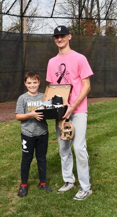 Wallkill Valley baseball team ‘strikes out’ cancer Tommy Kelly receives a pair of custom leats from Tyler Haberstrah at Wallkill Valley Little League’s Strikeout Cancer event.