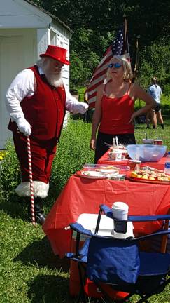 DAR holds annual Christmas in July Santa Claus contemplates more treats.