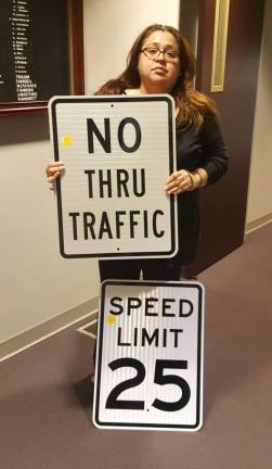 PHOTO BY ANNA ROSSFranklin resident brings street signs to a recent council meeting to address safety concerns of residents on South Rutherford Avenue.