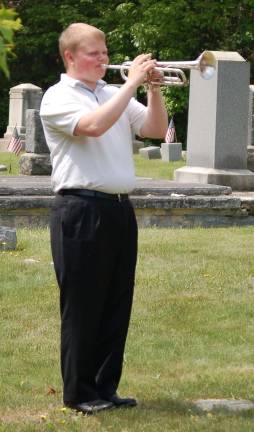 Danny Riordan, bugler from the County College of Morris Band, plays taps during the services.