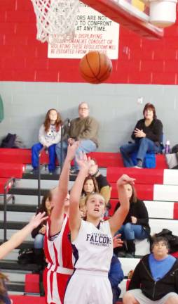Jefferson's Maddie Bowman launches the ball towards the basket under tight coverage.