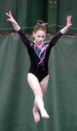 Gymnast Lexi Ingoglia floats above the balance beam. Ingoglia is a member of Westys Gymnastics.