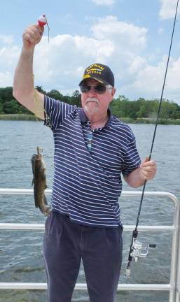 Vietnam veteran Pat Creighton of West Milford, New Jersey shows off a catfish he caught. Creighton served in the Army. On Saturday, June 10th 2017 The Double V Rod and Gun Club (Glenwood, New Jersey) members and volunteers hosted a group of disabled military veterans for a fun day of fishing followed by a barbecue at the Wallkill River National Wildlife Refuge in Sussex, New Jersey. The veterans were invited from several veterans hospitals in the region.
