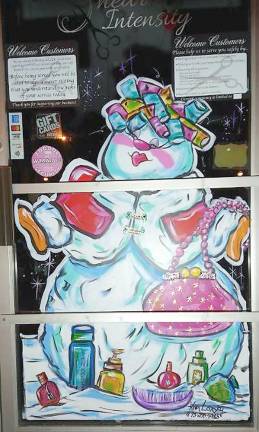 Artist gives businesses a boost with holiday paintings A painted holiday window at Shear Intensity in Sussex (Photo by Laurie Gordon)