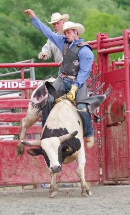 John Leinaweaver of Orrtanna, Pennsylvania participating in the bull riding event.