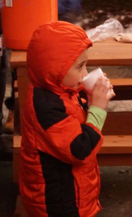 A small resident savors a cup of hot chocolate.