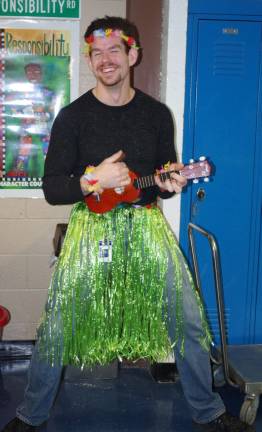 The show must go on Wearing a brilliant, bright green hula skirt, staffer Christian Frentzko espoused the wonders of ukulele playing.