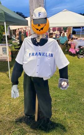 A scarecrow of a Franklin Miner is on display at the carnival