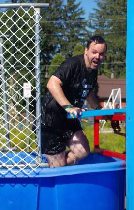 Vernon Township High School Music Director Max Taylor volunteered for the dunk tank in front of the Red Tail Lodge.