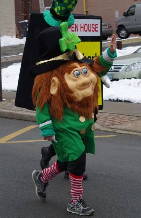 A leprechaun marches in the St. Patrick's Day Parade in Newton.