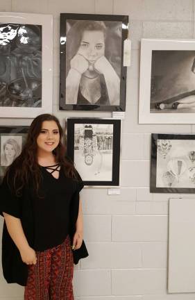 PHOTOS BY ANNA ROSS Carly Moyer, Warren Hills Regional High School, poses with her black and white drawing above right called Modern Day Thinker.