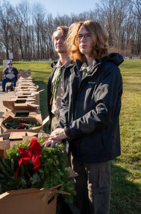 Boy Scouts Rhys Moore and Eric Walker prepare to open the boxes of wreaths.