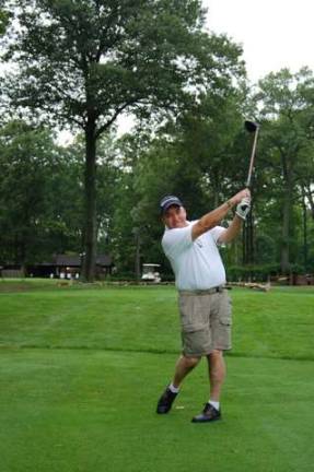 Alonso Strong Golf Outing hosts fundraiser Teeing off on the first tee is Dave Alonso, father of Aaron Alonso who was severely wounded in Afghanistan where he lost both legs.