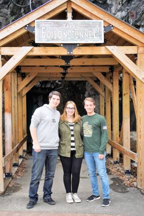 From left, Lucas Savarese, Mary Sutton, and Zack Zannetti stand before the Edison Tunnel leading to the Rainbow Tunnel.