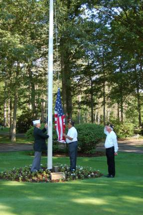 New Jersey Department of Veterans of Foreign Wars Vice Commander Lou Coars and Past Commander Dr. Clifford Williams, American Legion Post 423, prepare to raise the flag at the 40th annual Wiegand Farm Golf Outing in honor of Captain William Carroll who recently returned from Afghanistan. 3rd Vice Commander Larry Brain salutes the flag.