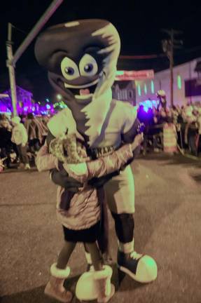 The Centenary University Cyclone mascot dances with a child on New Year’s Eve.