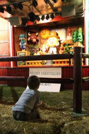 Smiles and fun at the fair Watching the singing vegetables.