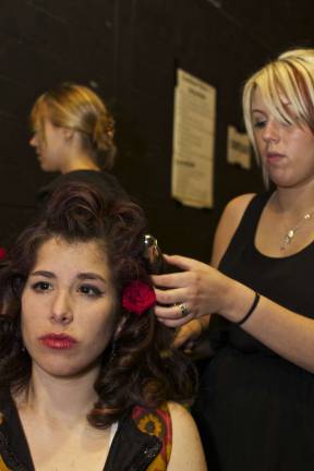 These fashionistas know how to sew Danielle Miserendino of Lafayette gets last minute hair and makeup adjustments before the fashion show.