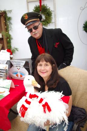 Train conductor Turner Striffler of Wantage stands behind Vernon author Leesa Beckmann and Oliver the Goose.