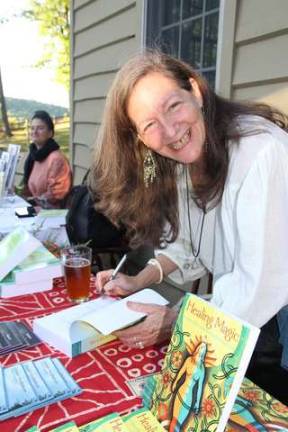Robin Rose Bennett signing her book &quot;Healing Magic.&quot;
