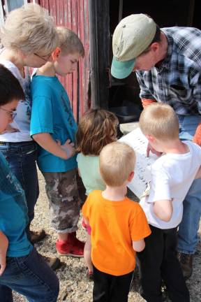 Area children get look at vernal ponds Going over the food chain chart on what frogs and salamanders eat.