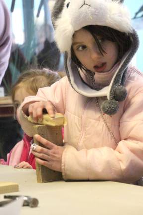 Madeline Norwood Orsi of Wantage is sanding her suit bird feeder project at the Wallkill Wildlife Refuge.