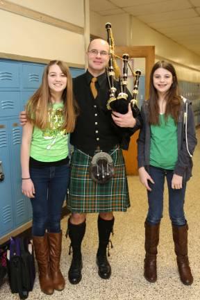 Bagpiper visited Franklin school Hannah Bodle and Taylor Burgos are shown with bagpiper Jeff Korger.