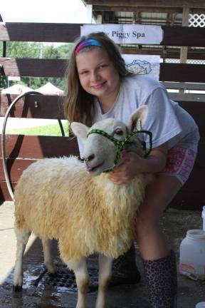 Summertime means County Fair Amanda Agne of Laffayette washes her sheep for the 4-H show. Smile for the camera. Photo by Gale Miko