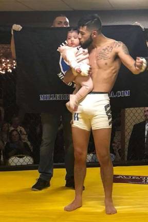 Miller Bros. scores four MMA wins Cristian Santos celebrates his victory with his daughter.