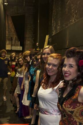 These fashionistas know how to sew Models and designers wait backstage before the fashion show.