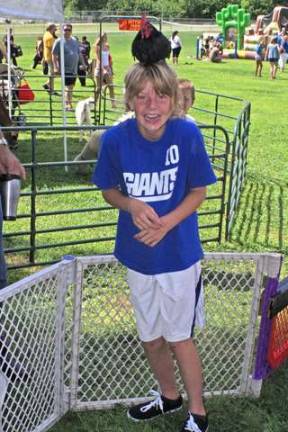 Hailey Munoz, 10, of Hardyston tries on a real live &#x201c;chicken hat&#x201d; at Hamburg Day 2014.