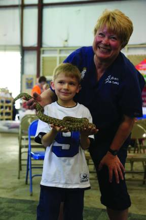 Furry, feathered and slimy friends Ben Ryan of Fredon holds a California King Snake with Lori Space Day's supervision.