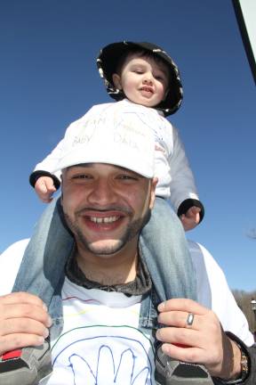 Luis Torres III of Hamburg on his dad's shoulders. The Torres Family is the Ambassador Family of the event.