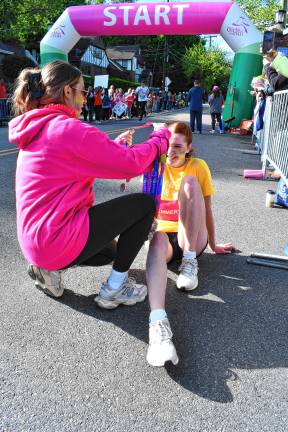 Photos: Girls on the Run Spring 5K Emery McDarby of Phillipsburg stretches out her leg after the race.