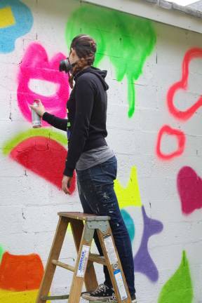 Last Sunday, artist Steph Burr of Torrington, Conn. began a mural on a garage wall at 40 Limekiln Road in Hamburg.