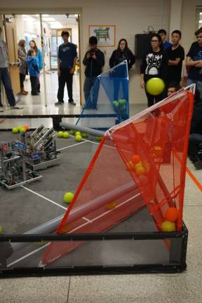Photos by Vera Olinski Competing teams of robots shoot balls into nets at the High Point VEX Robotic competition.