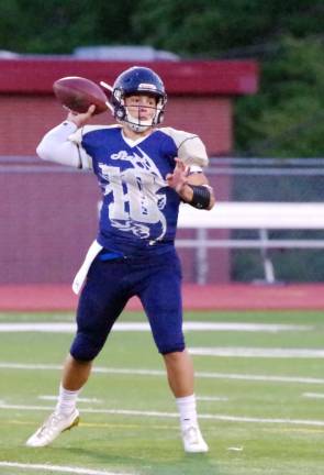Sussex Stags quarterback Adam Schlereth in throw motion as his teammates provide him protection in the first quarter.