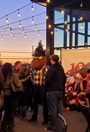 Herbie the Miner waits his turn to see Santa and Mrs. Claus at the Industry Restaurant + Bar holiday ribbon-cutting party Nov. 10.