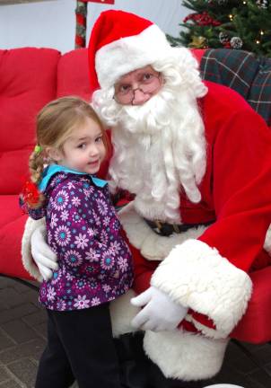 Lacey Wesloske, 3, of Vernon poses with Santa Claus.