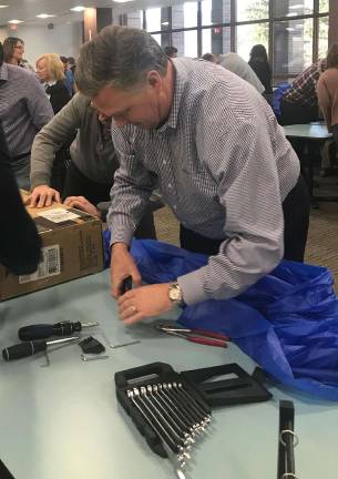 Selective's CEO, Greg Murphy, works on assembling his team's bike.