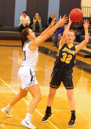 Jefferson's Alyssa Griswold is in the midst of passing the ball while covered by Sparta's Emily Dilger in the fourth quarter. Griswold scored 6 points.