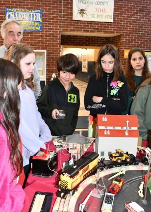 RR1 Sixth-grader Wyatt Fillhouse holds the remote control for model trains set up by the Sussex County Railroad Club at Hardyston Middle School. (Photo by Maria Kovic)