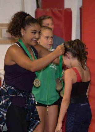 Giant Gymnastics raises money for juvenile arthritis Laurie Hernandez helped give medals.