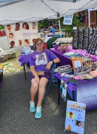 Eileen Frew poses at the Lilla Rose table.