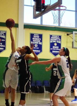 Sussex County's Olivia Bunge reaches high for a rebound.